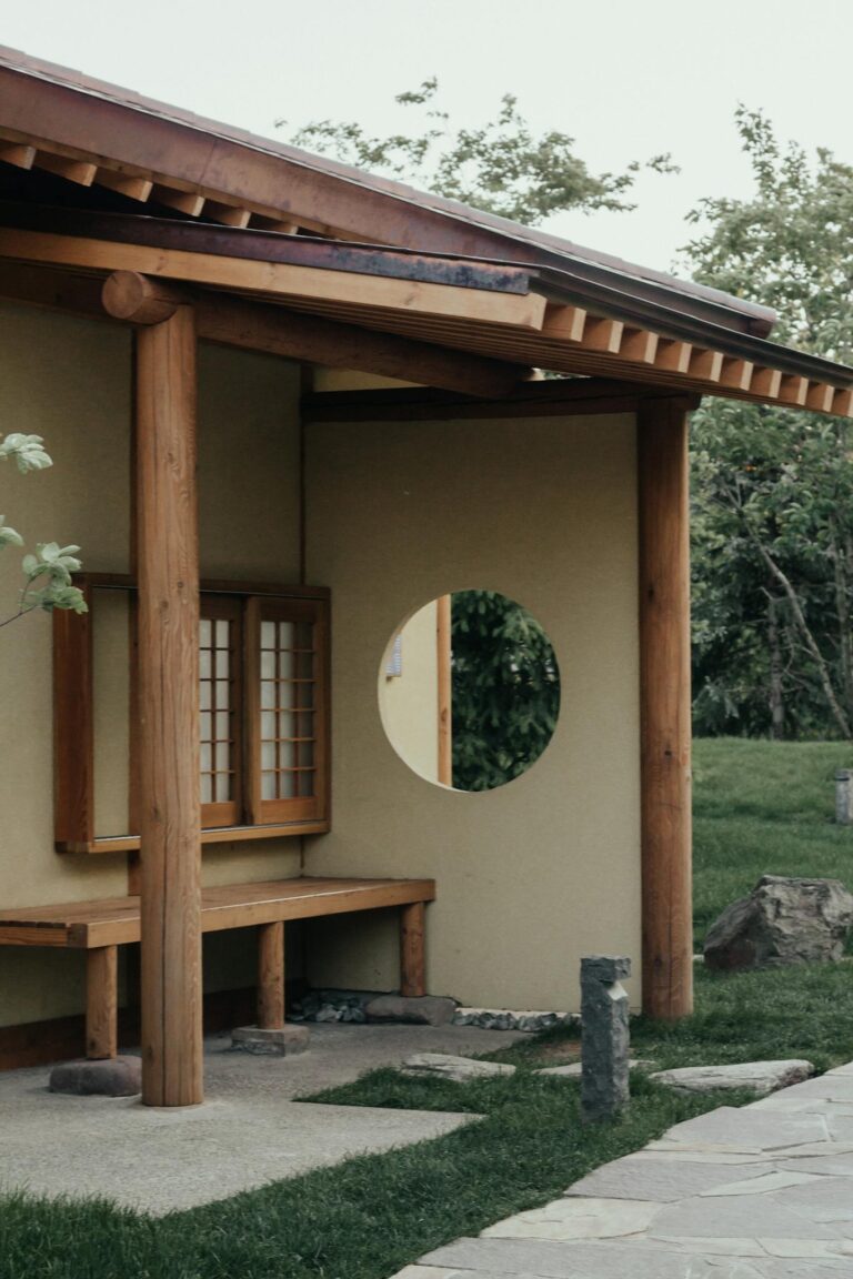Natural wooden beams and circular window detail on a rural building in Russia.